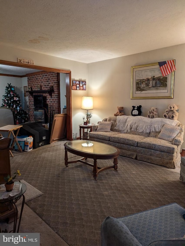 carpeted living room featuring a textured ceiling