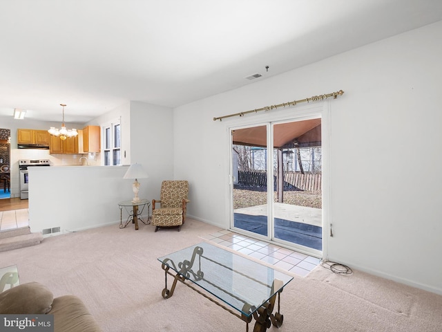 living room with a chandelier, light colored carpet, and visible vents