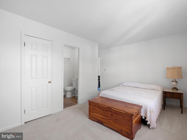 carpeted bedroom with connected bathroom