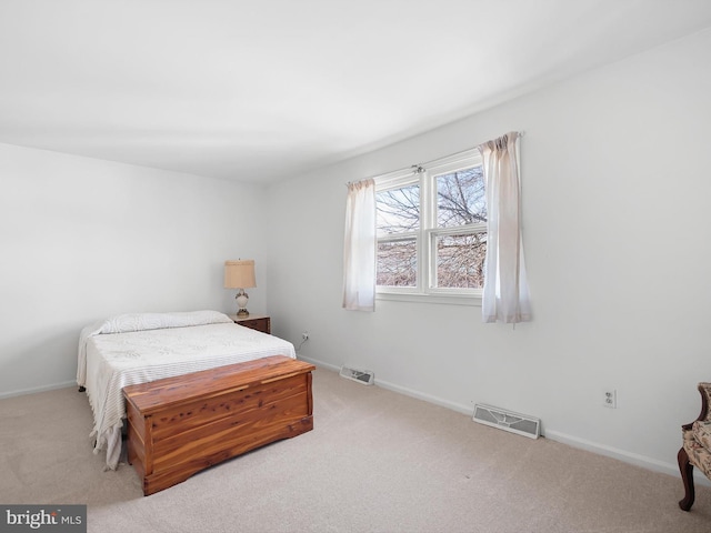 carpeted bedroom with visible vents and baseboards