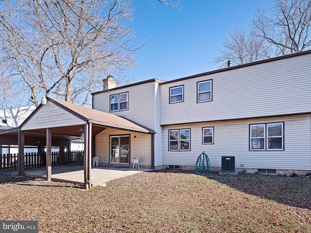 rear view of property with cooling unit, a patio, a chimney, and fence