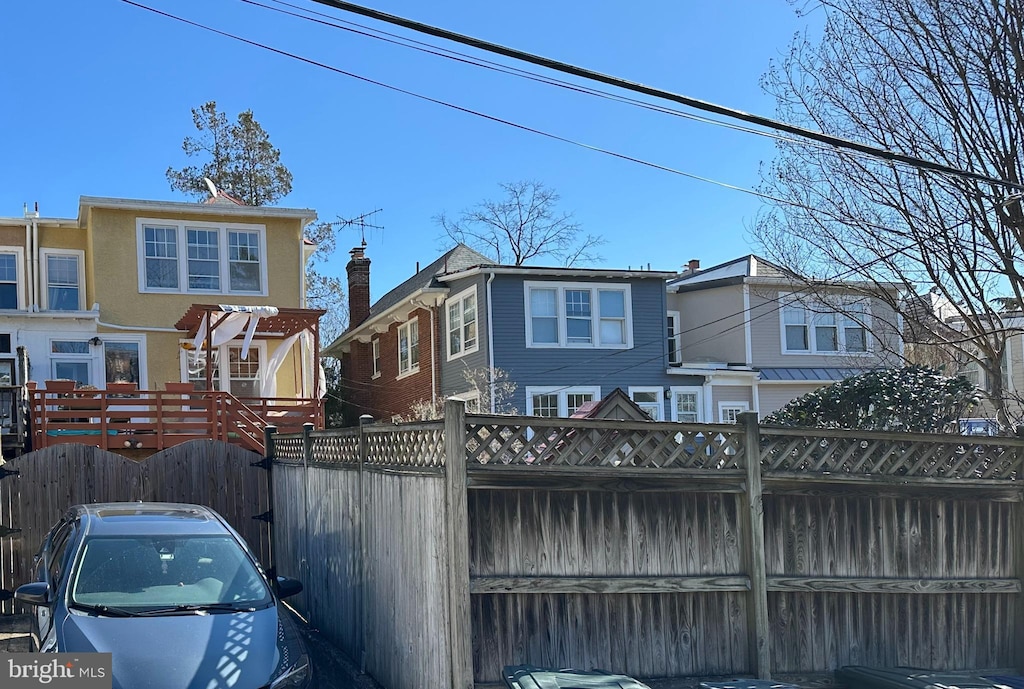 view of front of property featuring fence and stucco siding