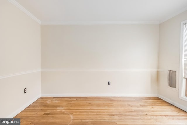 unfurnished room with light wood-style flooring, ornamental molding, and baseboards