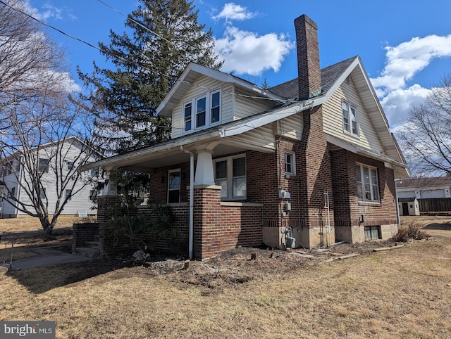 view of home's exterior featuring a chimney and brick siding