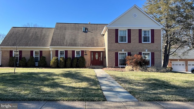 traditional-style home featuring brick siding and a front lawn