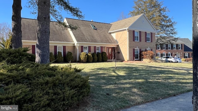 view of front facade featuring brick siding and a front lawn