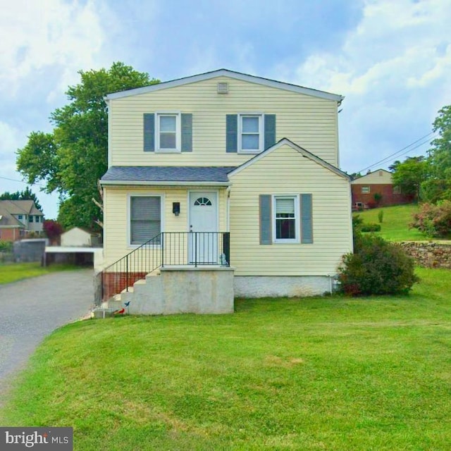 view of front of house with a front yard and driveway