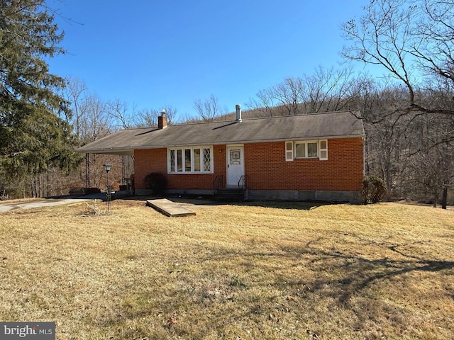 ranch-style home with entry steps, a carport, brick siding, and a front lawn