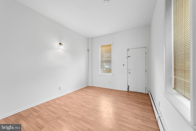 interior space with light wood-style flooring, baseboards, and baseboard heating