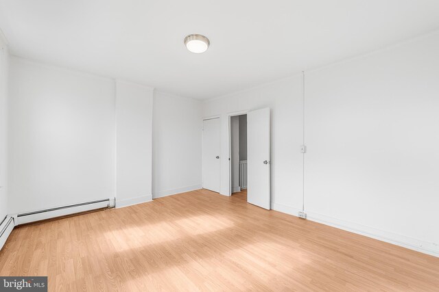 empty room with light wood-style floors and baseboards