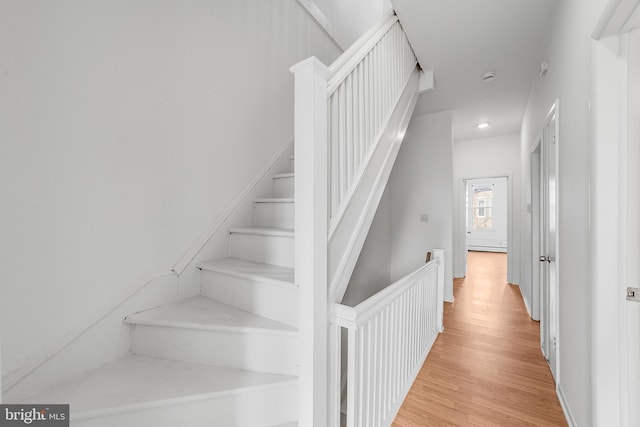 staircase with wood finished floors