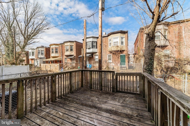 wooden deck featuring a residential view and fence