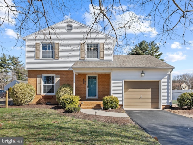 view of front of home featuring a front yard, an attached garage, a shingled roof, aphalt driveway, and brick siding