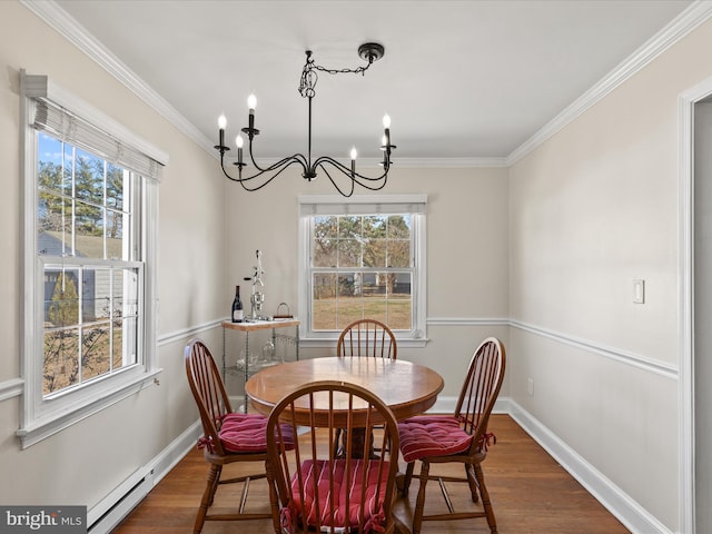 dining space with baseboards, plenty of natural light, and wood finished floors