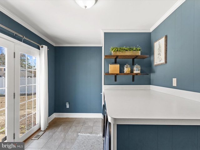 interior space featuring baseboards, light countertops, ornamental molding, tile patterned floors, and open shelves