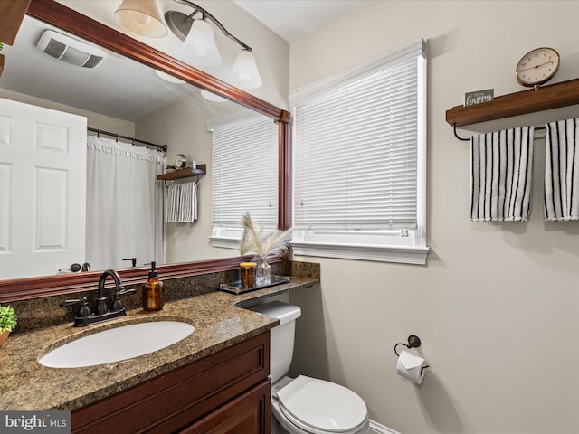 full bathroom with visible vents, toilet, and vanity