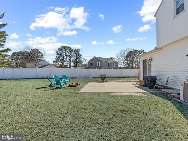 view of yard with a fire pit, a fenced backyard, and a patio area