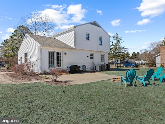 rear view of house with central air condition unit, a patio, a lawn, and entry steps