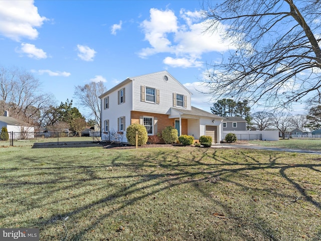 view of front of property with a front yard, brick siding, an attached garage, and fence