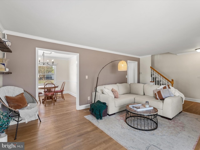 living room featuring baseboards, wood finished floors, and ornamental molding