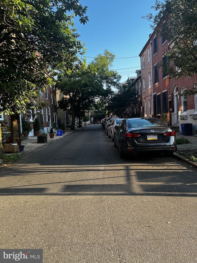 view of road featuring curbs, sidewalks, and a residential view