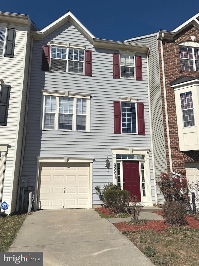 multi unit property with a garage and concrete driveway