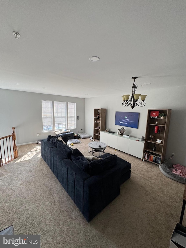 carpeted living area featuring a notable chandelier