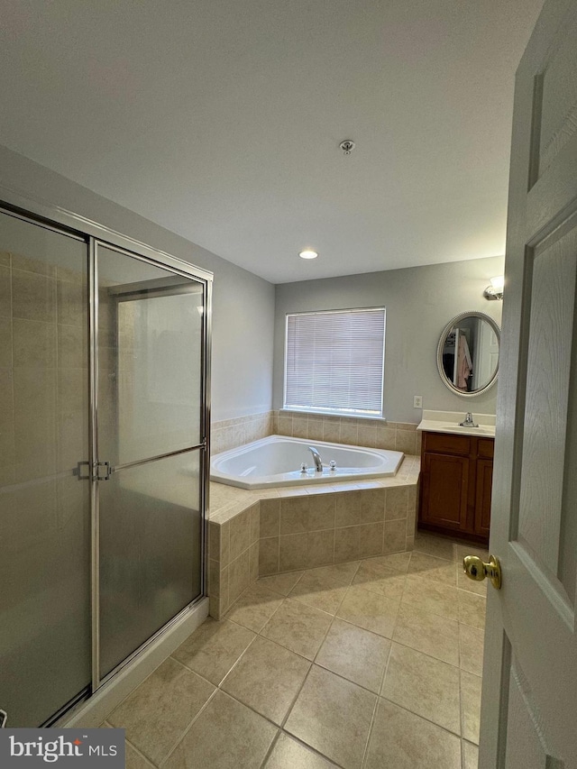 bathroom featuring tile patterned floors, a shower stall, vanity, and a garden tub