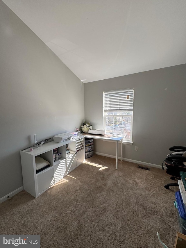 unfurnished office with visible vents, lofted ceiling, carpet, and baseboards