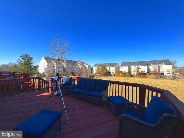 wooden terrace featuring a residential view, an outdoor hangout area, and a yard