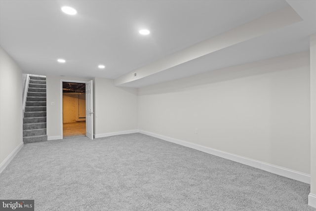 finished below grade area with carpet floors, recessed lighting, stairway, and baseboards