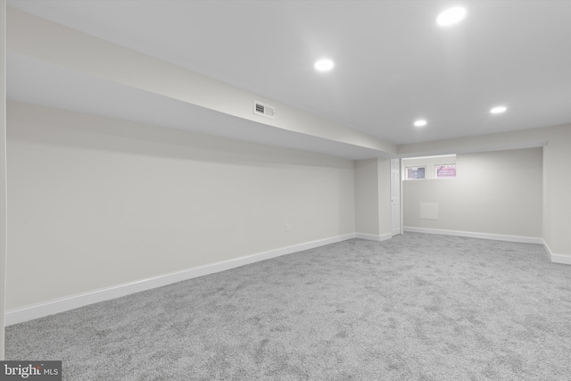 finished below grade area featuring recessed lighting, carpet flooring, visible vents, and baseboards