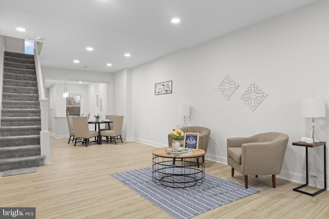 living area featuring stairs, baseboards, wood finished floors, and recessed lighting