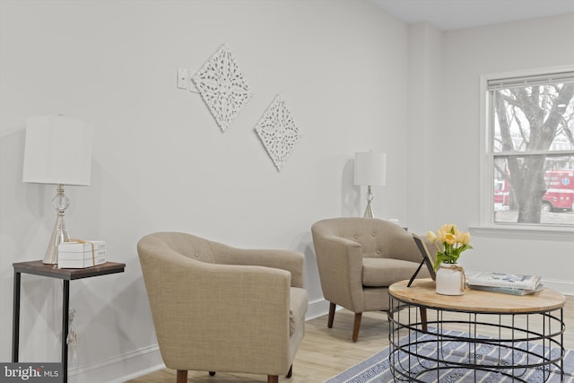 living area with light wood finished floors and baseboards