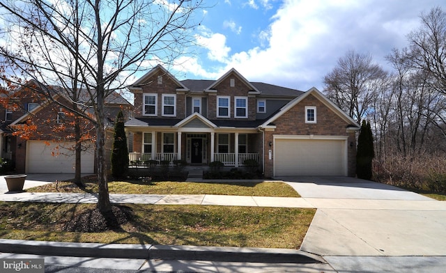 craftsman-style house with covered porch, driveway, and brick siding