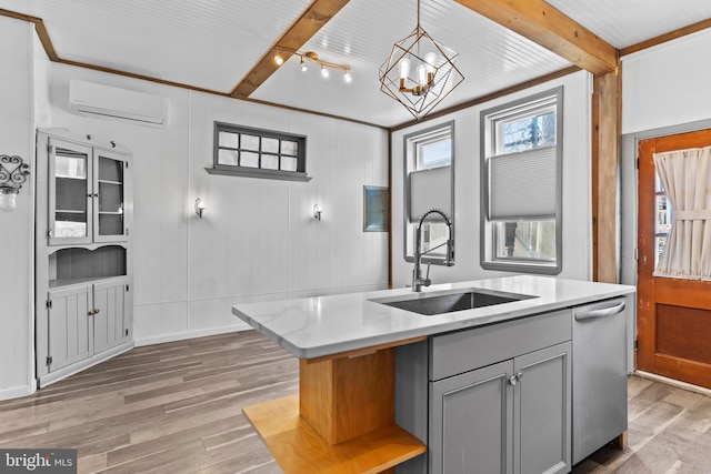 kitchen featuring a sink, stainless steel dishwasher, gray cabinets, beam ceiling, and a wall mounted air conditioner