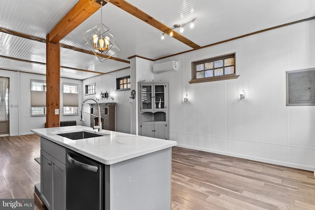 kitchen featuring beam ceiling, light wood-style flooring, stainless steel dishwasher, a sink, and electric panel