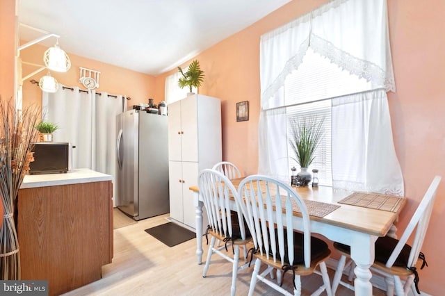 dining space featuring light wood-type flooring