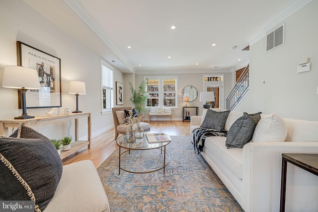 living area featuring visible vents, crown molding, baseboards, recessed lighting, and wood finished floors