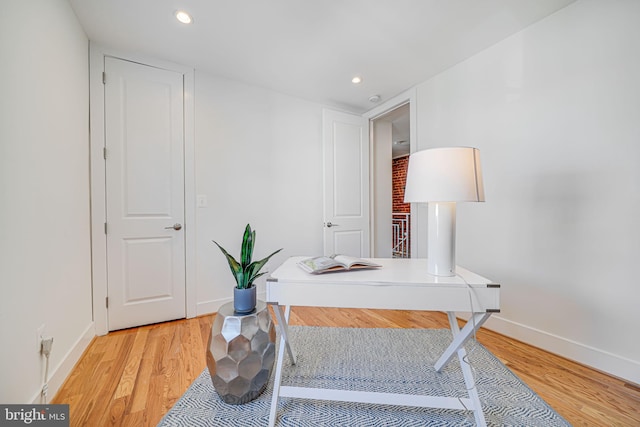 office area with recessed lighting, baseboards, and light wood finished floors