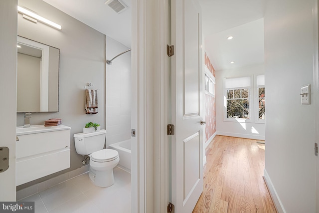 full bath with visible vents, toilet, vanity, and baseboards