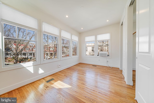 unfurnished sunroom featuring visible vents and cooling unit