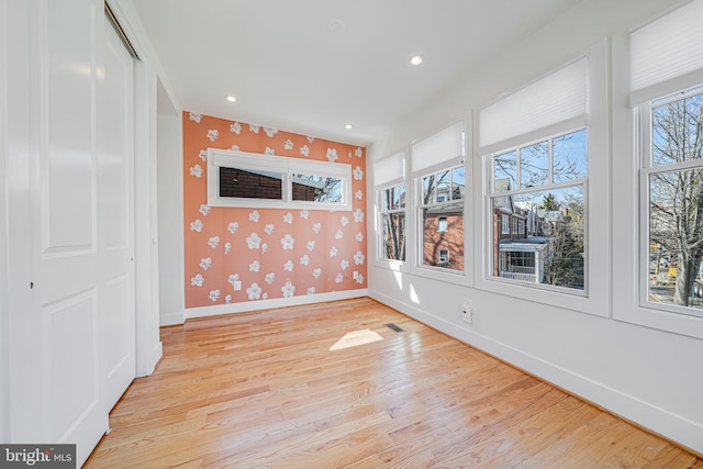 unfurnished room featuring visible vents, baseboards, wallpapered walls, recessed lighting, and light wood-style floors