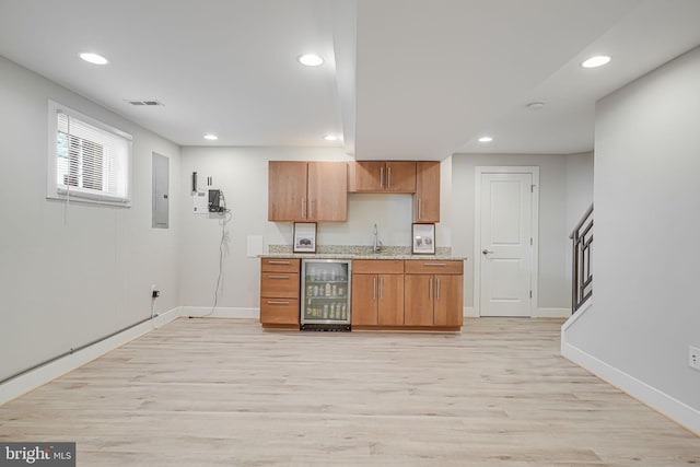 kitchen featuring visible vents, beverage cooler, electric panel, recessed lighting, and light wood finished floors