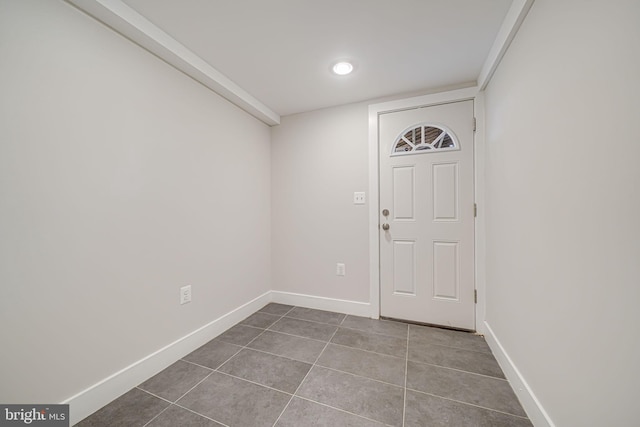 foyer featuring tile patterned flooring and baseboards