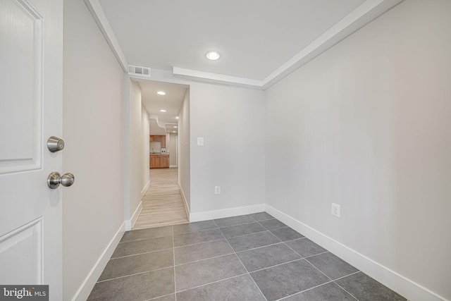 empty room with recessed lighting, visible vents, baseboards, and dark tile patterned flooring