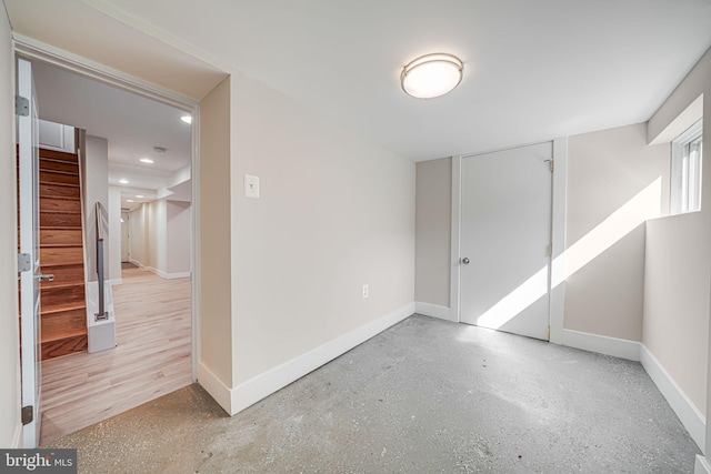 empty room with stairway, recessed lighting, and baseboards