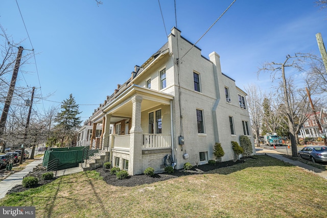 view of home's exterior featuring brick siding and a lawn