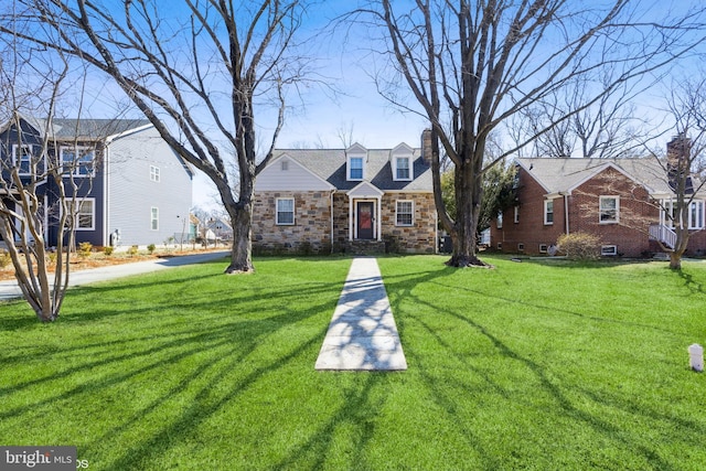 view of front facade with stone siding and a front lawn