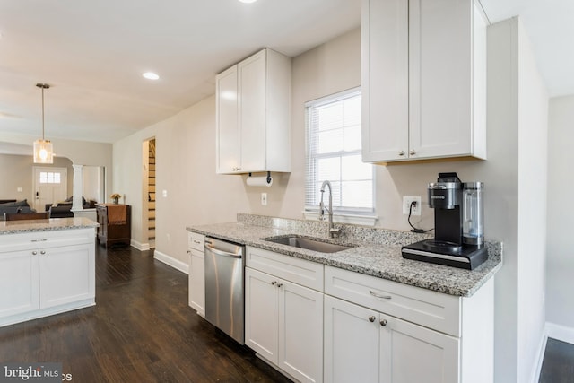 kitchen with a sink, white cabinetry, a healthy amount of sunlight, dishwasher, and dark wood finished floors